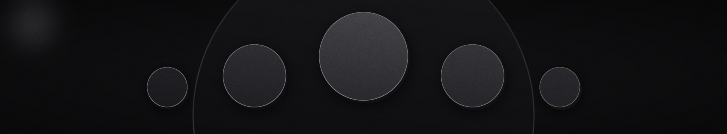 Five matte discs of different sizes held in balance